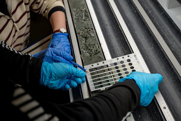 Scientists analyze the core samples from below the Atlantic using the Munsell Soil Colour Chart.